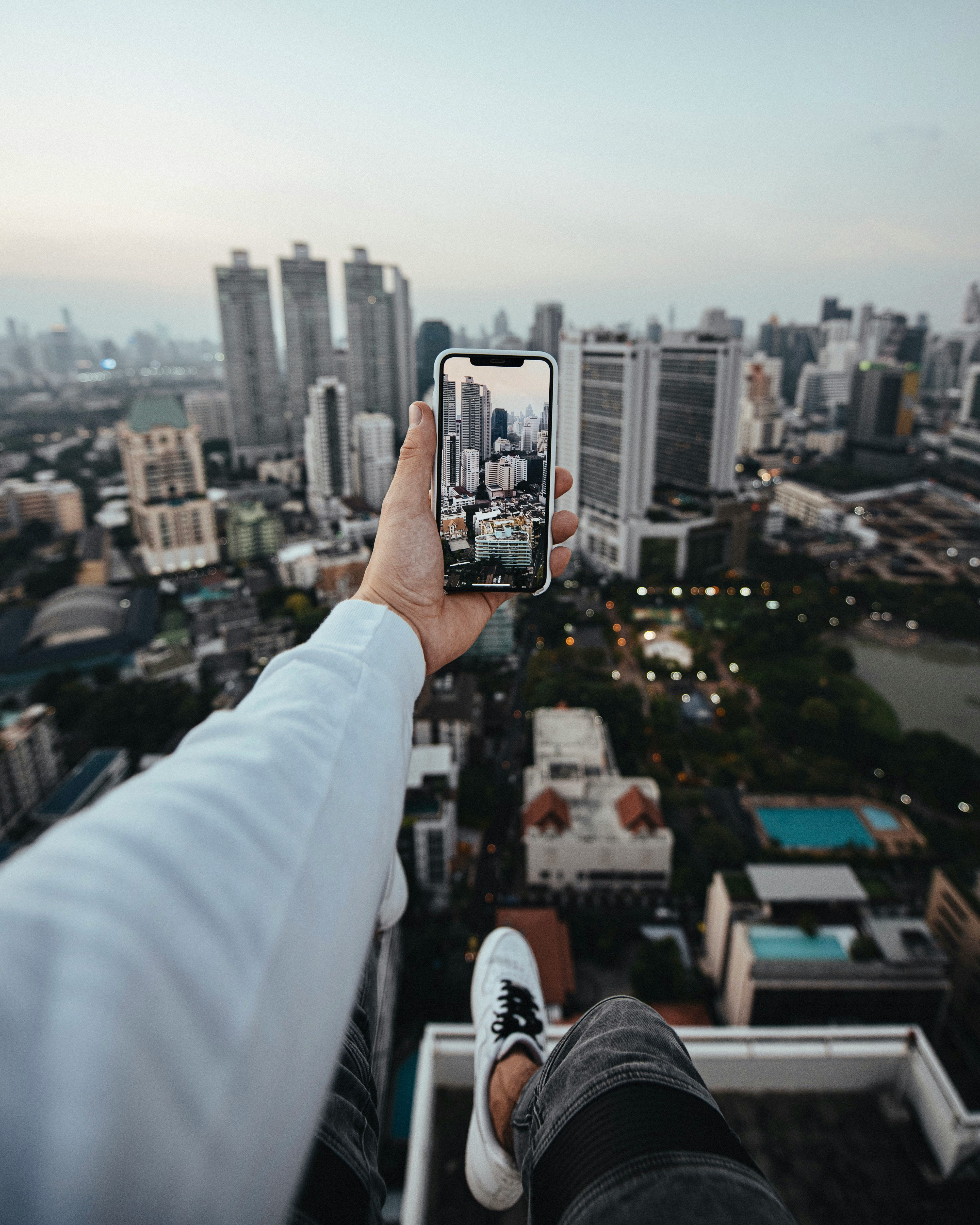 selective focus photography of person talking photo of city buildings